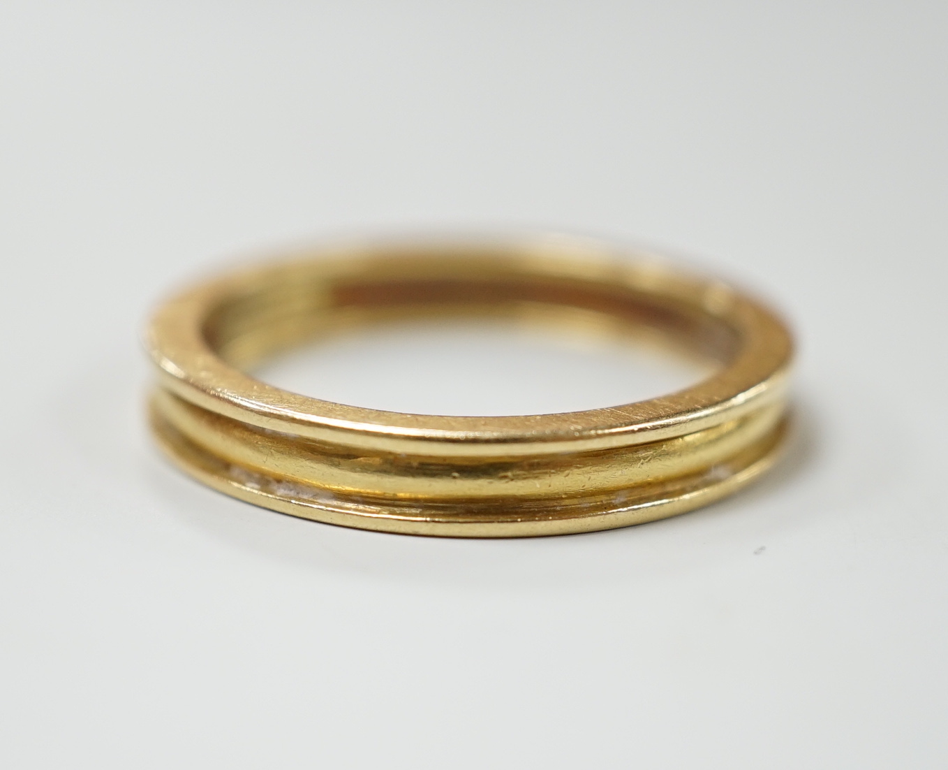 A modern Theo Fennel 18ct gold band, size R, gross weight 4.8 grams.